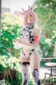 A woman in a cow costume posing for a picture.