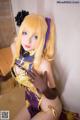 A woman in a purple and gold outfit posing for a picture.