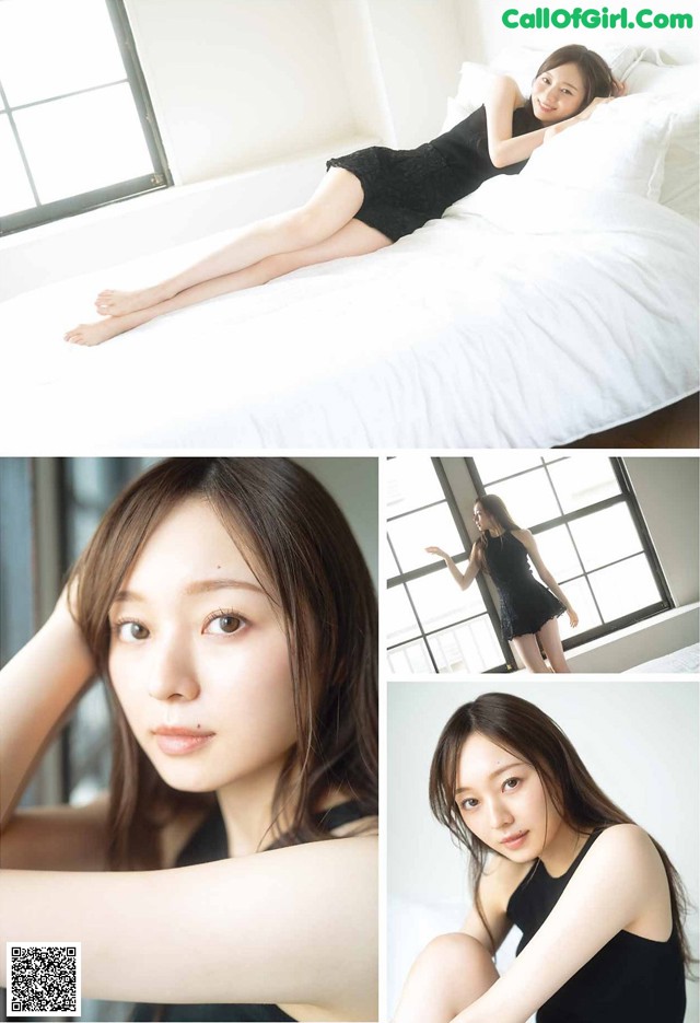 A woman in a black dress laying on a bed.